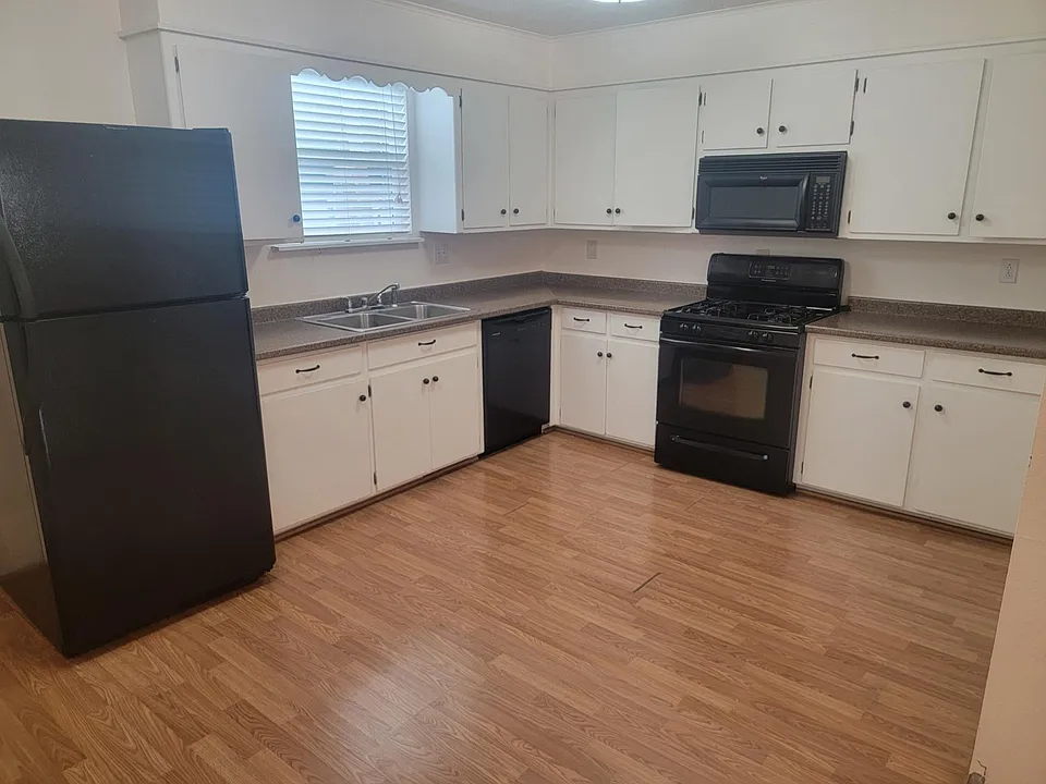 Spacious kitchen with gas cooking, dishwasher and microwave.