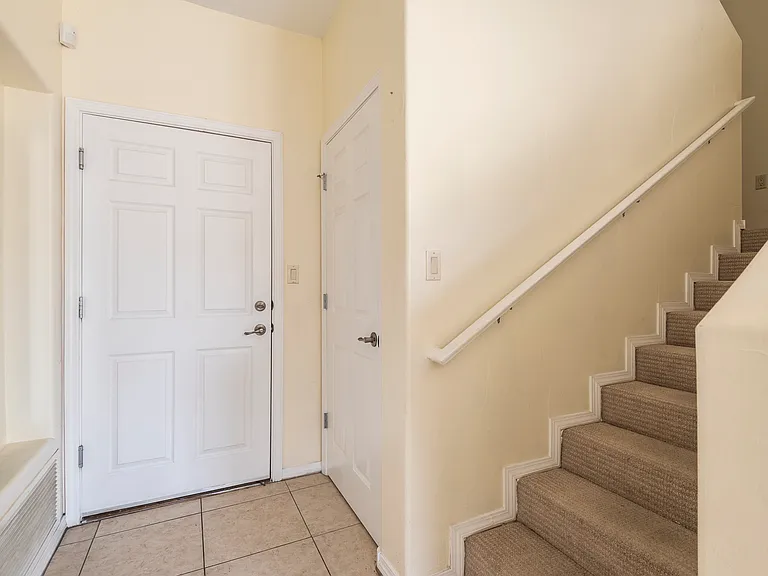Door to garage, closet, and stairs.