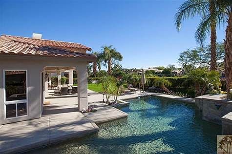 Gorgeous custom pool wraps the southern corner of this beautiful home.