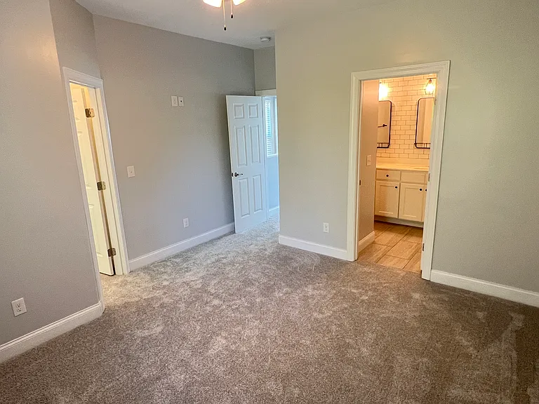Upstairs master bedroom with walk-in closet and full bath featuring dual vanities.
