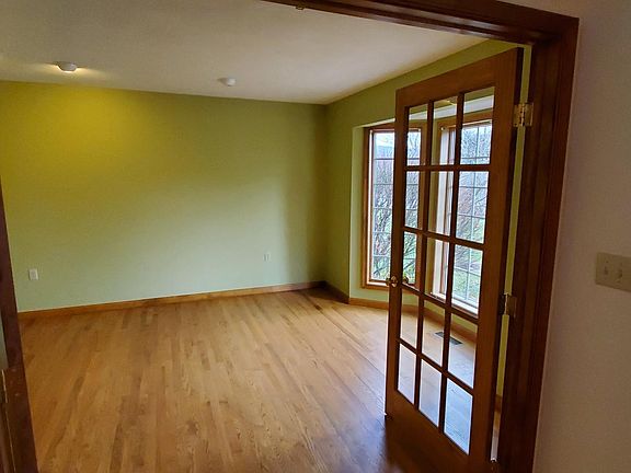 Office or library with French doors and bay window.