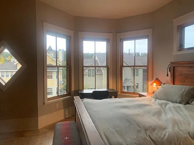 master bedroom with lots of windows and mountain/downtown Truckee views