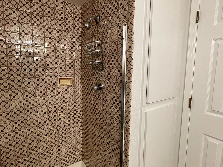 Upstairs shower with beautiful hand-painted Mexican tile. Built-in cabinets offer plenty of storage