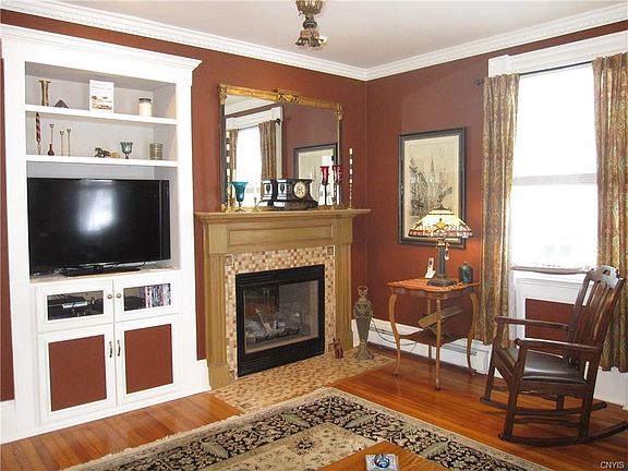 The fireplace is two-sided, the tiling is new.  Most older homes have no place for television sets, but this TV is perfectly situated.  Living room exclusions include the drapes, the mirror over the fireplace, and the hanging light.  Other exclusions thro