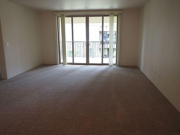 Huge living room with balcony, sliding door, ceiling fan