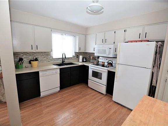 Kitchen with updated backsplash, sink and lighting
