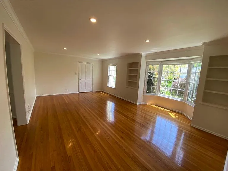 Living room from opposite side of the room towards front door entrance.