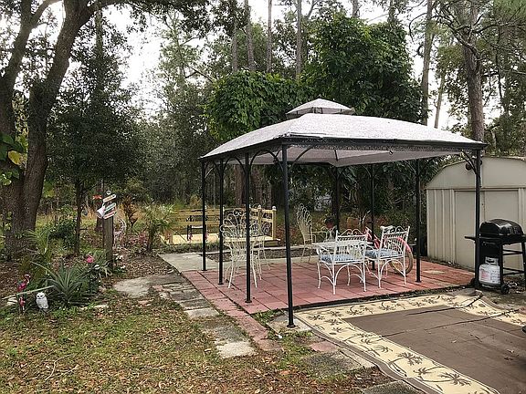 Patio with gazebo by deck