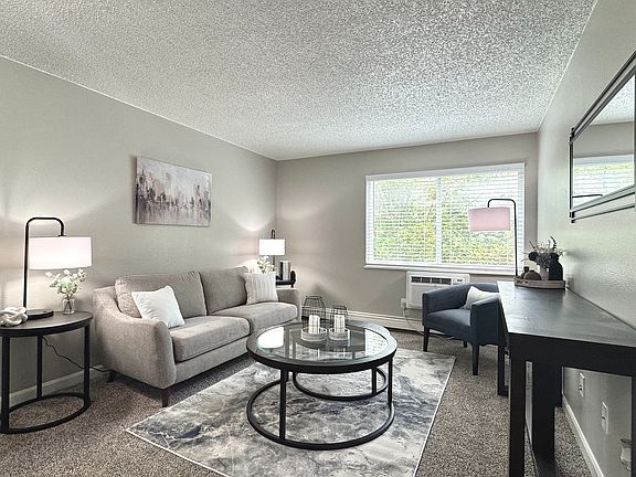 Spacious living room with natural light and stylish, modern furnishings