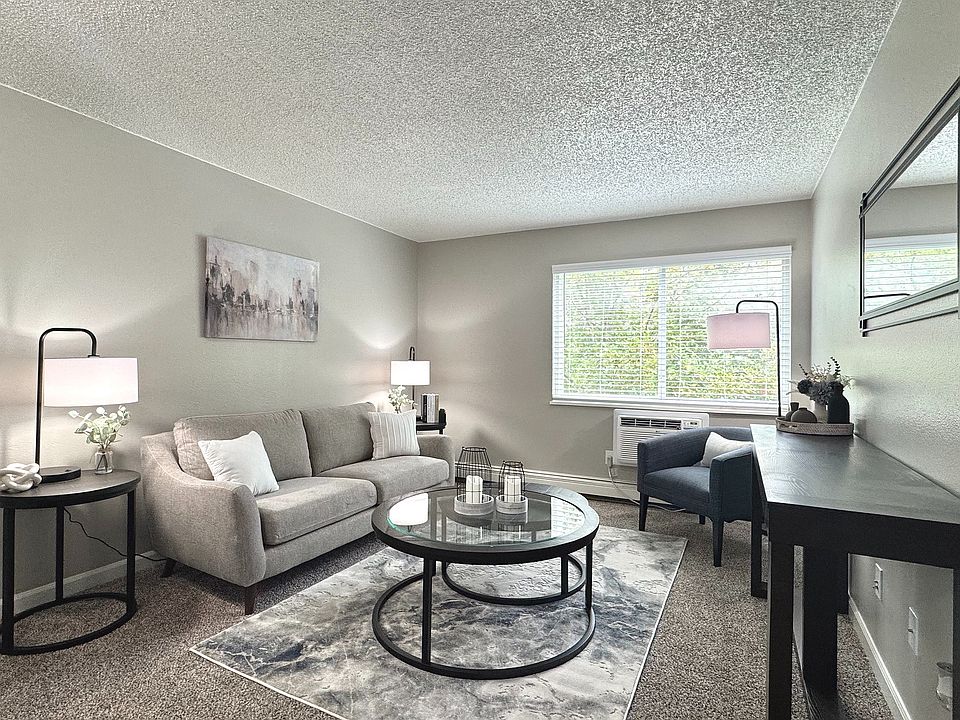 Spacious living room with natural light and stylish, modern furnishings