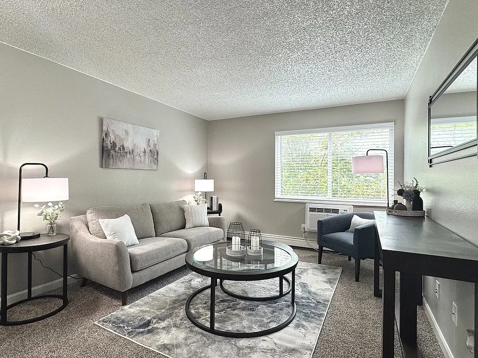 Spacious living room with natural light and stylish, modern furnishings