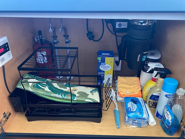 Under the kitchen sink.