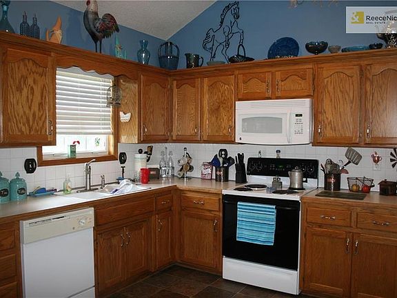 Kitchen offers good amount of cabinet space and new vinyl floors.  Window looks out to back of the house.