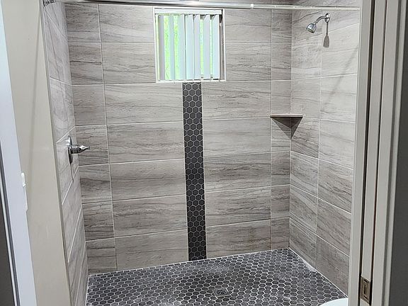 Primary bedroom private shower and toilet.