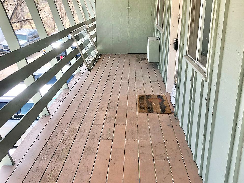 Step outside into tranquility on this spacious, covered balcony designed for relaxation.