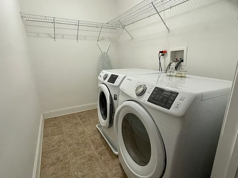 Convenient upstairs laundry room with added storage and everyday functionality