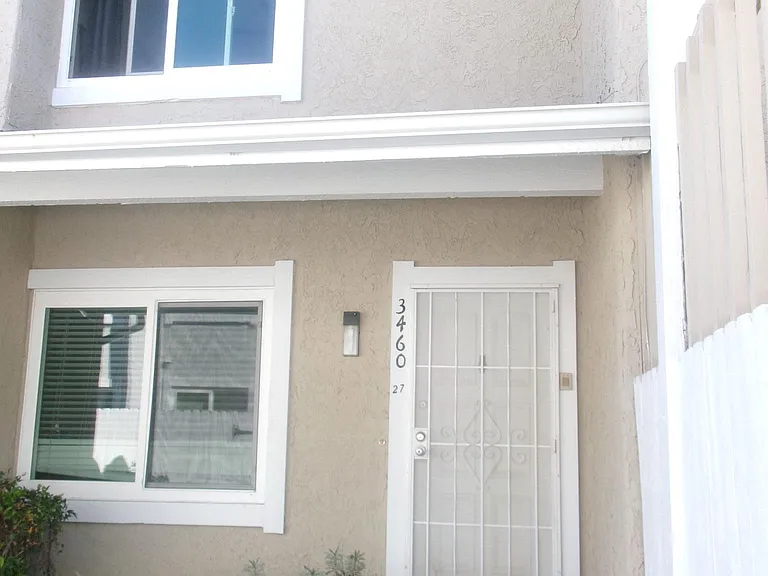 Front door to townhome. Larger bedroom is the upstairs window.