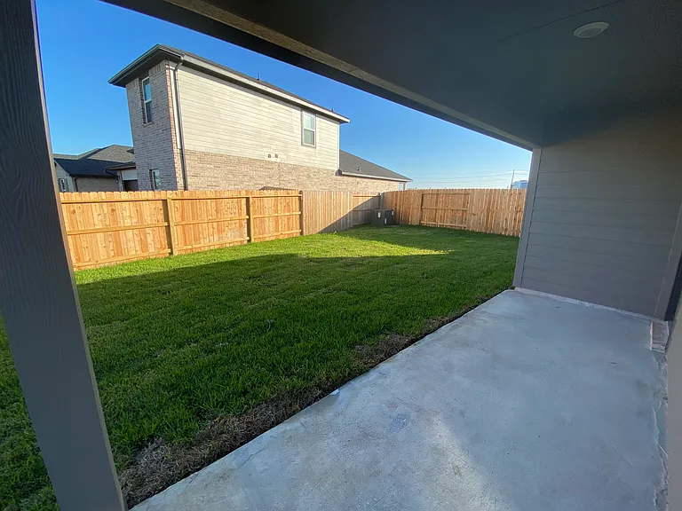 View of part of the patio space and backyard
