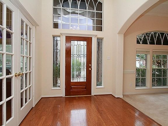 Foyer has hardwood floors and coffered ceiling
