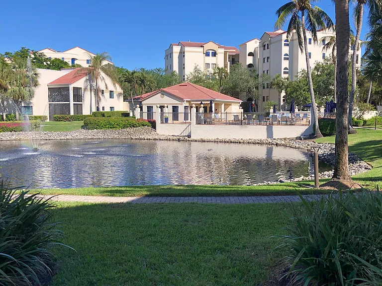 Beautiful view from our lanai of lake, pool deck, and clubhouse