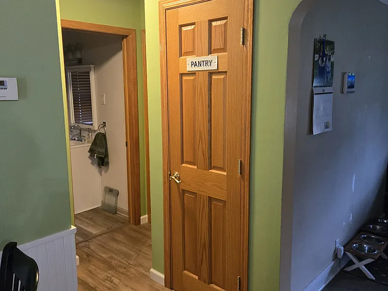 Small hallway between kitchen, living room, upstairs bathroom and rental room
