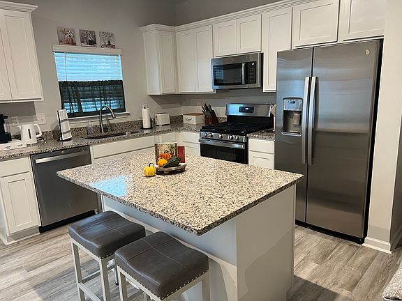 Kitchen with gas stove, refrigerator, dishwasher and microwave built in. Also all small appliances available such as hot water kettle, toaster, Keurig, can opener, mixer, rice cooker, air fryer, crockpot, blender and more. Granite countertops