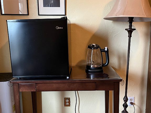 The room features a mini-fridge and tenant's choice of an electric tea kettle or a coffeemaker.