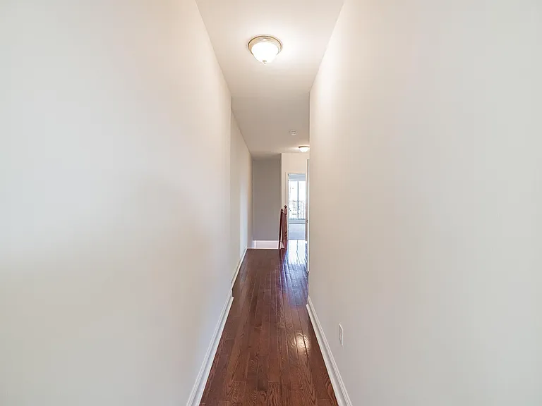 Third floor hallway descending to second floor .