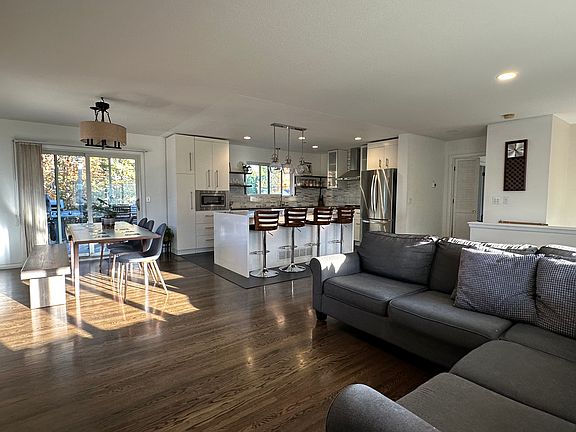 Dining area has patio doors that lead out to large deck with pergola.