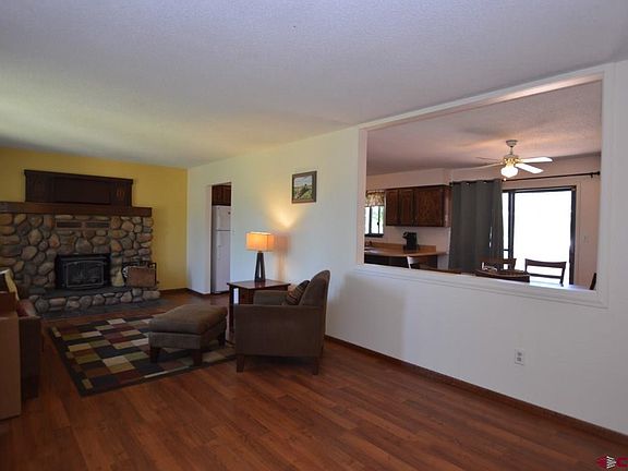 Living room opens to kitchen and dining area at both ends.