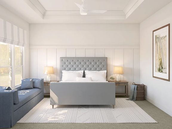 Primary suite with decorative feature wall and tray ceiling