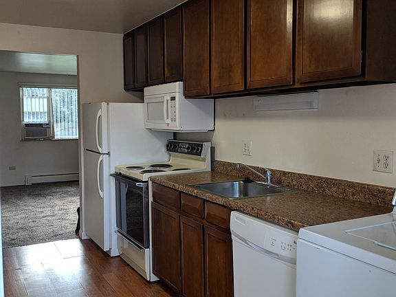 Kitchen with hard wood flooring and appliances