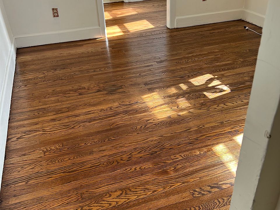 Newly renovated hardwood floors in living room dining room and hallway