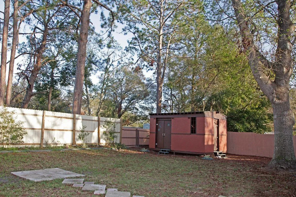 A piece of the backyard, all fenced in . There is a large shed that can be used for storage or shop if you wish to run electricity, none at the moment. - 1342 Francis St