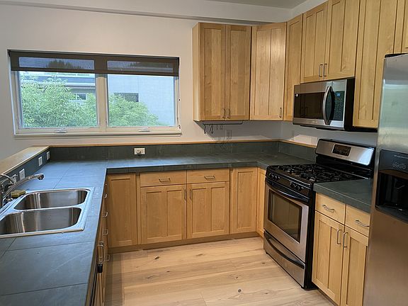 Kitchen with views of treetops.