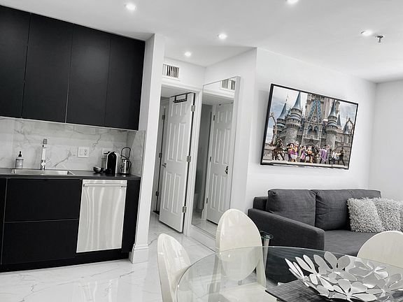 Dining & Living room with sofa group and 70 inch Smart TV. One sofa can be single bed