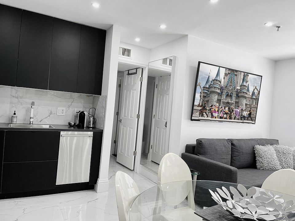Dining & Living room with sofa group and 70 inch Smart TV. One sofa can be single bed