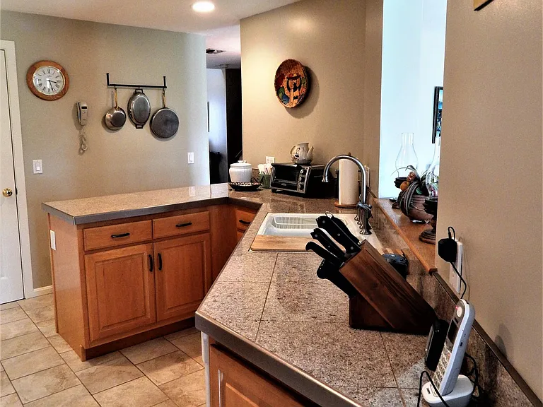 functional well-equipped custom kitchen, Kohler deep double sink with cutting board, dishwasher, disposer