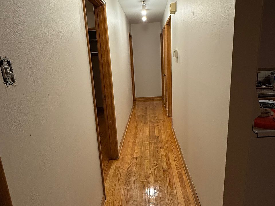 Central corridor leaving from living space to bedroom and bathrooms. A large storage closet is behind door.