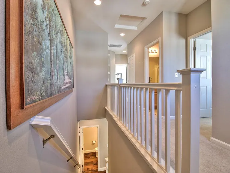Stairs to the second floor. First room on the right is guest room, followed by guest bathroom. Master and third room can be seen at the far end of the picture