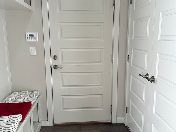 Garage (2 cars) entrance, with mud room/storage bins on one side and brand new washer/dryer on the other side