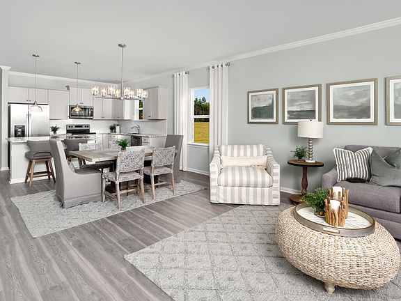 Open main living areas that connect the kitchen to the cafe area and the gathering room. Model Repre