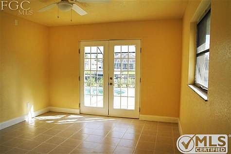 Master bedroom with a view to the pool and the canal