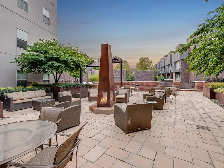 Unwind in the outdoor lounge with a cozy fire pit, perfect for year-round relaxation.