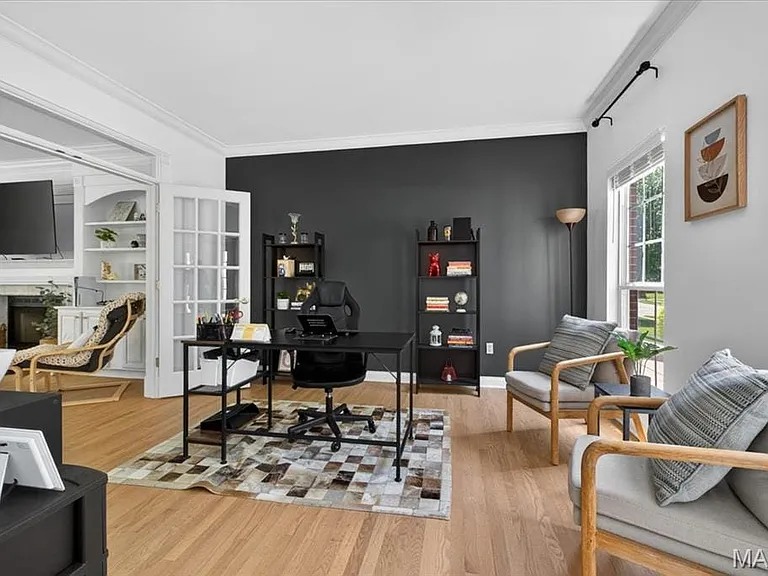 Hardwood flooring throughout, featuring a dark accent wall