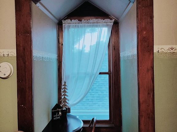 Dormer window with a desk and chair.