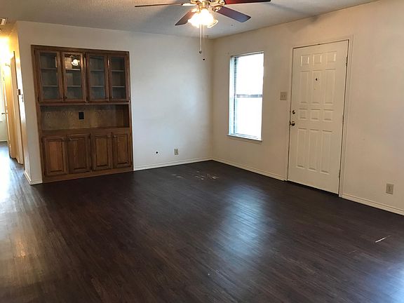 Living room with built in cabinets and shelves
