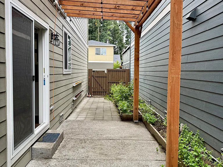 fenced side yard. ample space for growing veggies, flowers. Cement base for BBQ