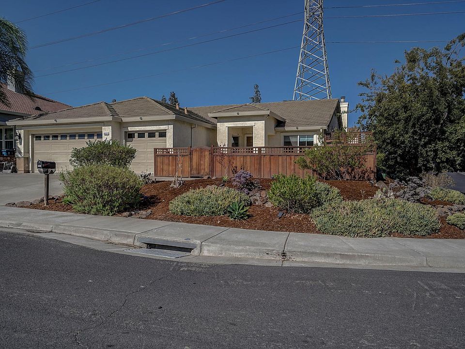 Front view with landscape, 3 car driveway and 3 car garage