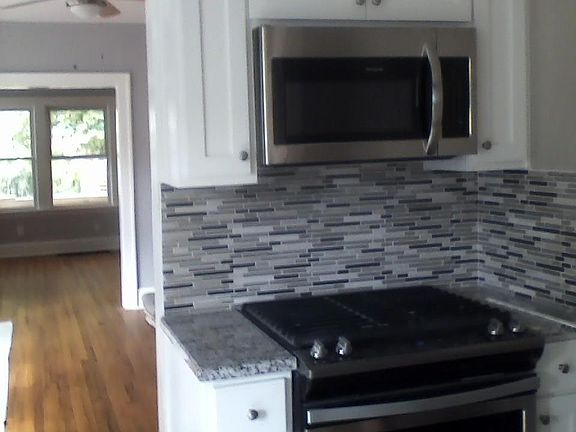 Kitchen view of dining room and living room. New kitchen cab
